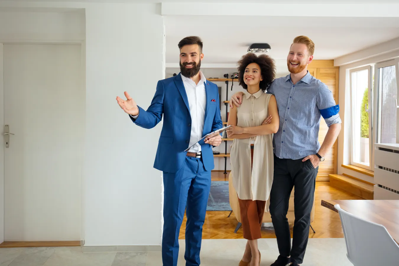 Property practitioner showing a home to a couple during an indoor viewing